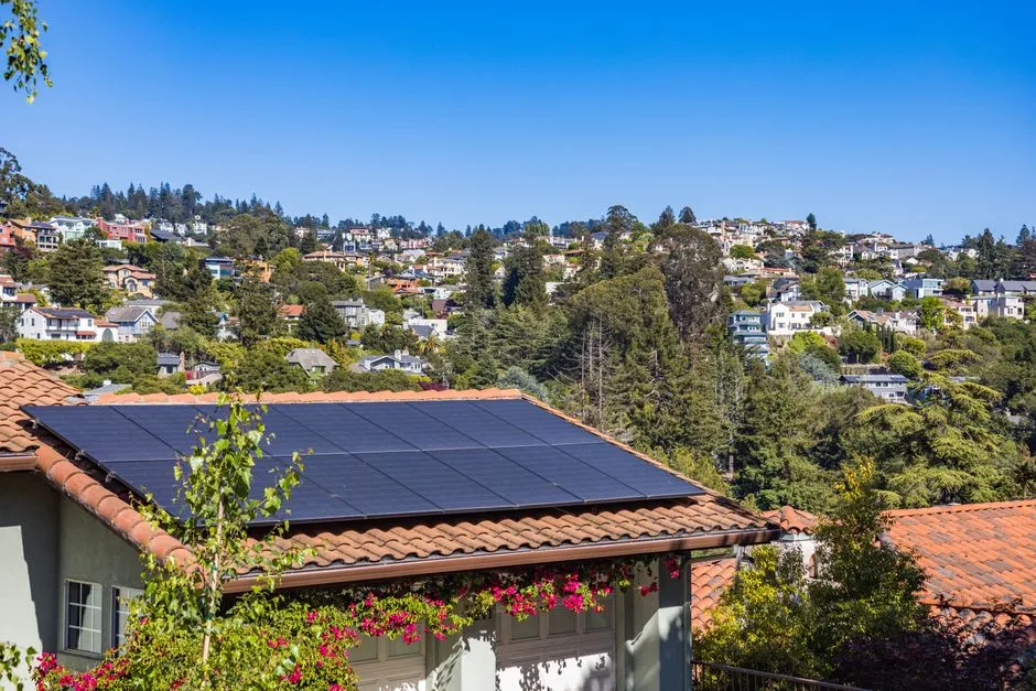 Panneaux solaires sur le toit d'une maison, couplés à un ballon thermodynamique pour produire l'eau chaude